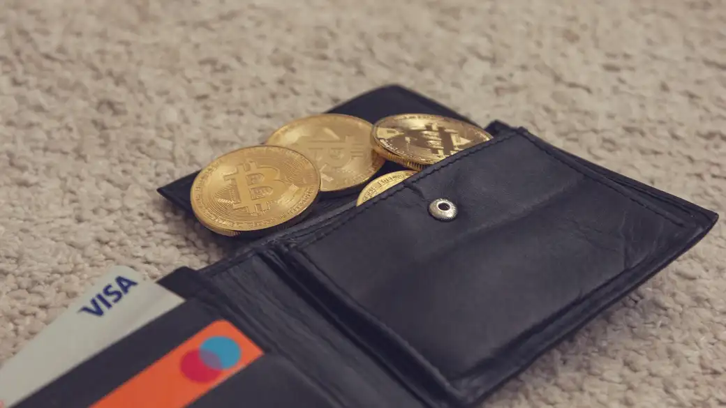 Physical Bitcoin coin resting on a laptop keyboard, representing the boundary between online balances and offline key storage