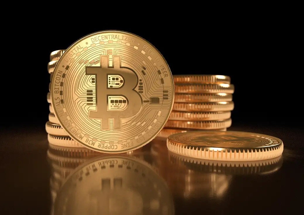 Bitcoin token photographed on a dark surface, representing long-term cold storage savings
