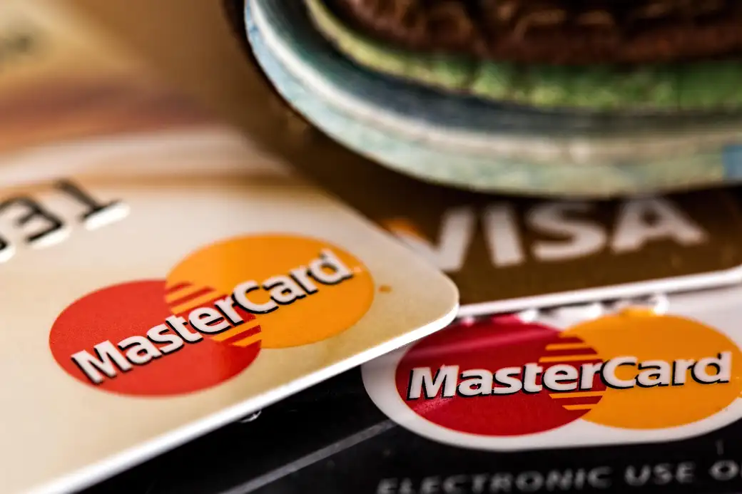 Payment card and phone, representing verifying a destination before sending funds