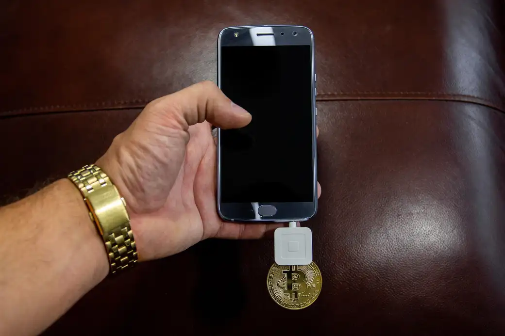Cryptocurrency tokens beside a hardware device, illustrating secure key custody